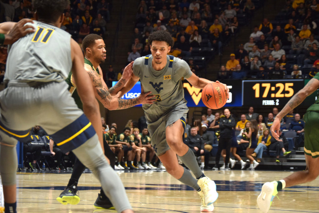 West Virginia forward Tre Mitchell plays basketball.